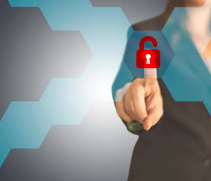 Person pointing at a digital red padlock icon on a screen with hexagonal pattern background.